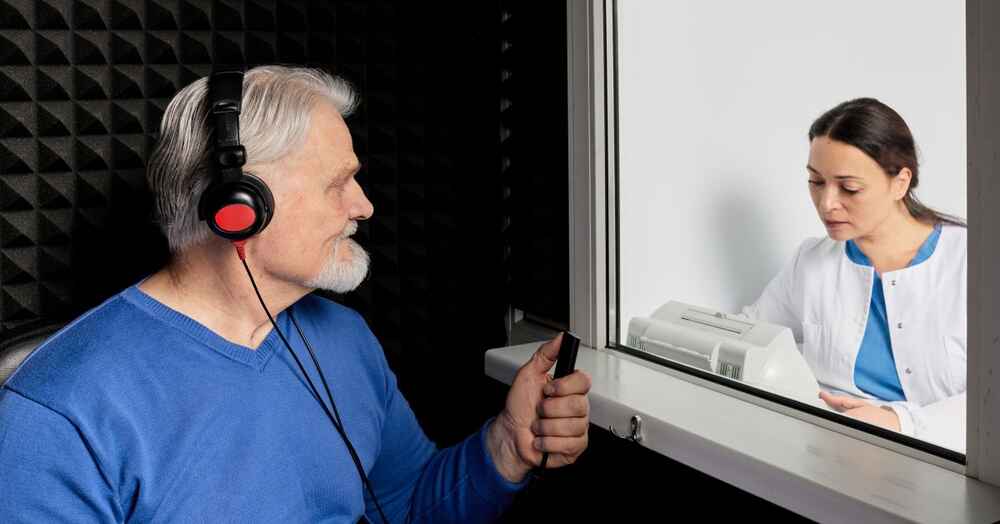 Man doing a hearing test with an audiologist