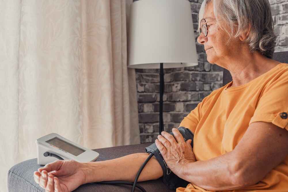 Senior woman measuring her high blood pressure